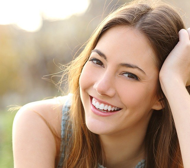 Woman sharing flawless smile after tooth colored filling restoration